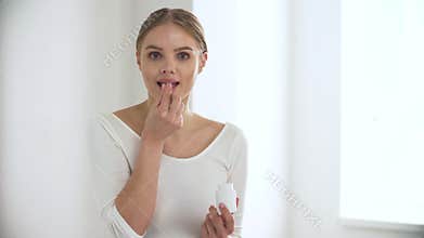 Healthcare. Happy woman taking pill and putting in mouth