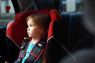 Child in auto baby seat in car