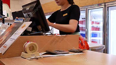 Motion of young girl makes a purchase and pays at the checkout with phone