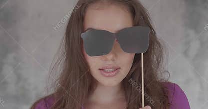 Portrait of pretty girl with photo booth prop