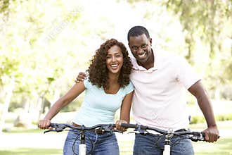 Couple On Cycle Ride in Park