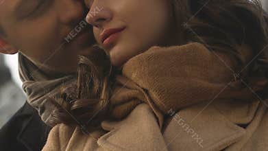 Man in love embracing woman from behind, happy couple expressing affection