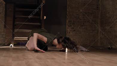 Young beautiful girl ballerina is dancing, spining, stairs on background, lights on floor, ballet concept, movement
