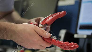 Close up of male engineer working on bionic hand.