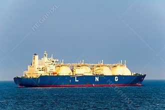 Large liquefied natural gas LNG carrier with 4 LNG tanks sails in the sea