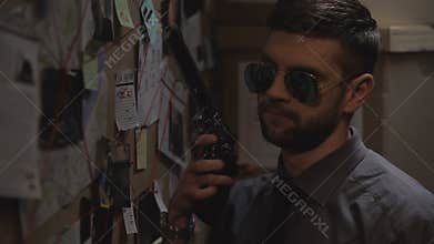 Heroic responsible policeman with gun in hand coming out to fight, law and order