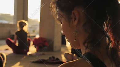 Yogi girl is meditating in group in abandoned building in summer on sunrise, healthy lifestyle, movement concept, sport