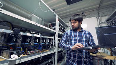 Man works with computers, mining cryptocurrencies.