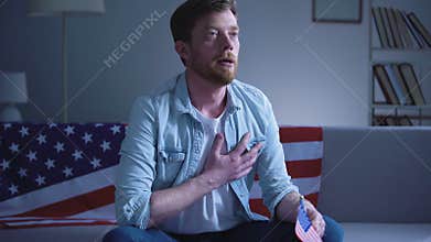 Emotional patriot singing American national anthem, hand on heart love for state