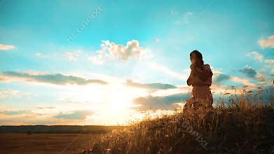 Girl folded her hands in prayer silhouette at sunset. lifestyle woman praying on her knees. slow motion video. Girl