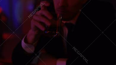 Man drinking alone in bar, pondering over important decision, correcting failure