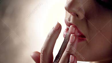 Lip care. Woman touching soft lips with fingers closeup