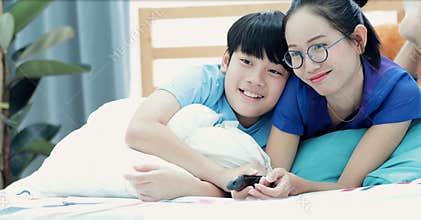 Mother and son having fun and couch watching TV.