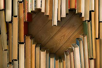 Love concept of heart shape from old vintage books on wooden flo