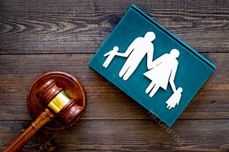 Family law, family right concept. Child-custody concept. Family with children cutout near court gavel on dark wooden