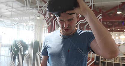 Man using virtual reality glasses then taking off VR goggles headset