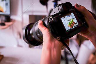 Saigon/Vietnam, 13 July 2018 - A photographer taking food photos with DSLR Camera in a Food studio