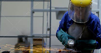 Female welder using grinder in workshop 4k