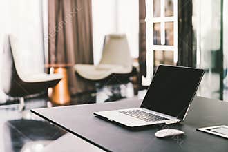 Laptop computer on work table in modern luxury contemporary office. Corporate business, internet information technology concept