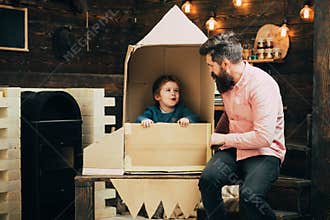 Father and small boy in paper rocket. Family and childhood. father day. Earth day concept. Education and kid idea