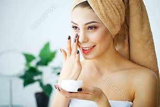 A beautiful woman using a skin care product, moisturizer or lotion and Skincare taking care of her dry complexion. Moisturizing c