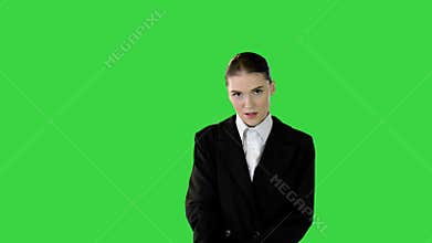 Young woman adjusting her office suit, crossing arms, putting hand on hip on a Green Screen, Chroma Key.