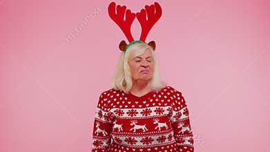 Upset senior Christmas old woman making face palm gesture, feeling bored, disappointed, bad result