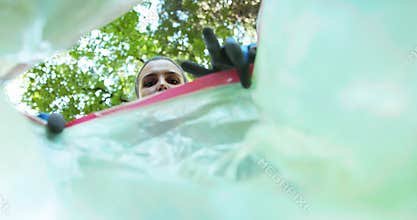 Cleanup volunteer putting trash in a garbage bag