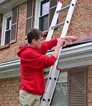 Man on Ladder on a roof