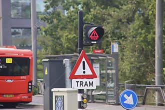 Red warning sign with sound and lights at tram passing point