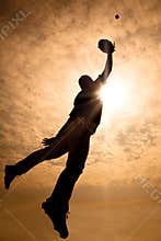 baseball player jumping into air to make the catc