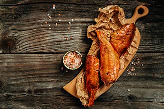 Hot smoked river bass fish on wooden cutting board. banner, menu, recipe place for text, top view