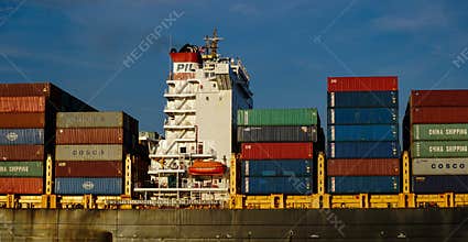 Shipping containers crowd the deck of an oceangoing ship. An important component of the global supply chain.
