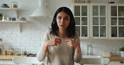 Thoughtful young asian woman holding distant conversation.