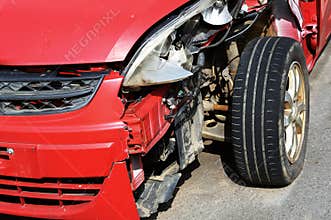 Front end of wrecked red car, accident