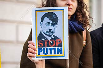LONDON, ENGLAND- 26 February 2022: Putin Hitler placard at a protest against Russia`s invasion of Ukraine