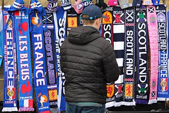Man Looking at Rugby Scarves