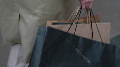 Girl carries shopping bags in the mall