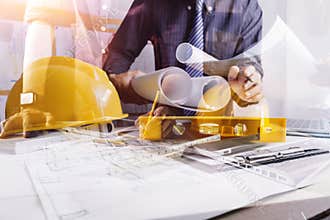 Architect or engineer working in office with blueprints,engineer inspection in workplace for architectural plan,sketching a