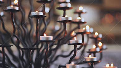 Candlestick holder with burning candles in a Catholic church.
