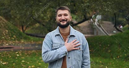 Thankful man keeping hand on his chest