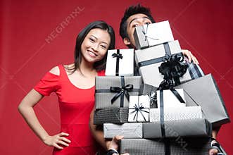 Asian Smiling Couple holding gifts