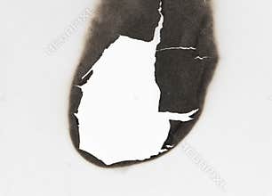 Burnt hole  on white paper. burns borders paper close up