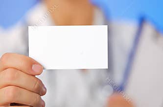 Doctor (woman) holding blank business card