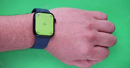 A Person with a Smart watch on a green screen