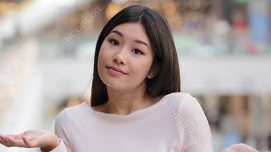 Portrait asian korean unsure embarrassed girl female model student unaware puzzled 20s woman throwing arms out to sides