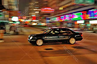 Speeding car in Hong Kong by night