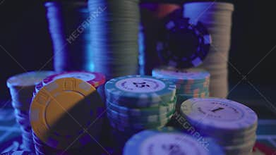 Casino chips on a dark table. Concept of gambling or poker and entertainment. Close up macro shoot. Online casino