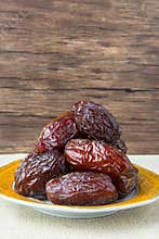 Delicious medjool dates ( kurma ) or sweet dried dates on a plate
