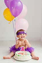 One year old birthday girl with cake